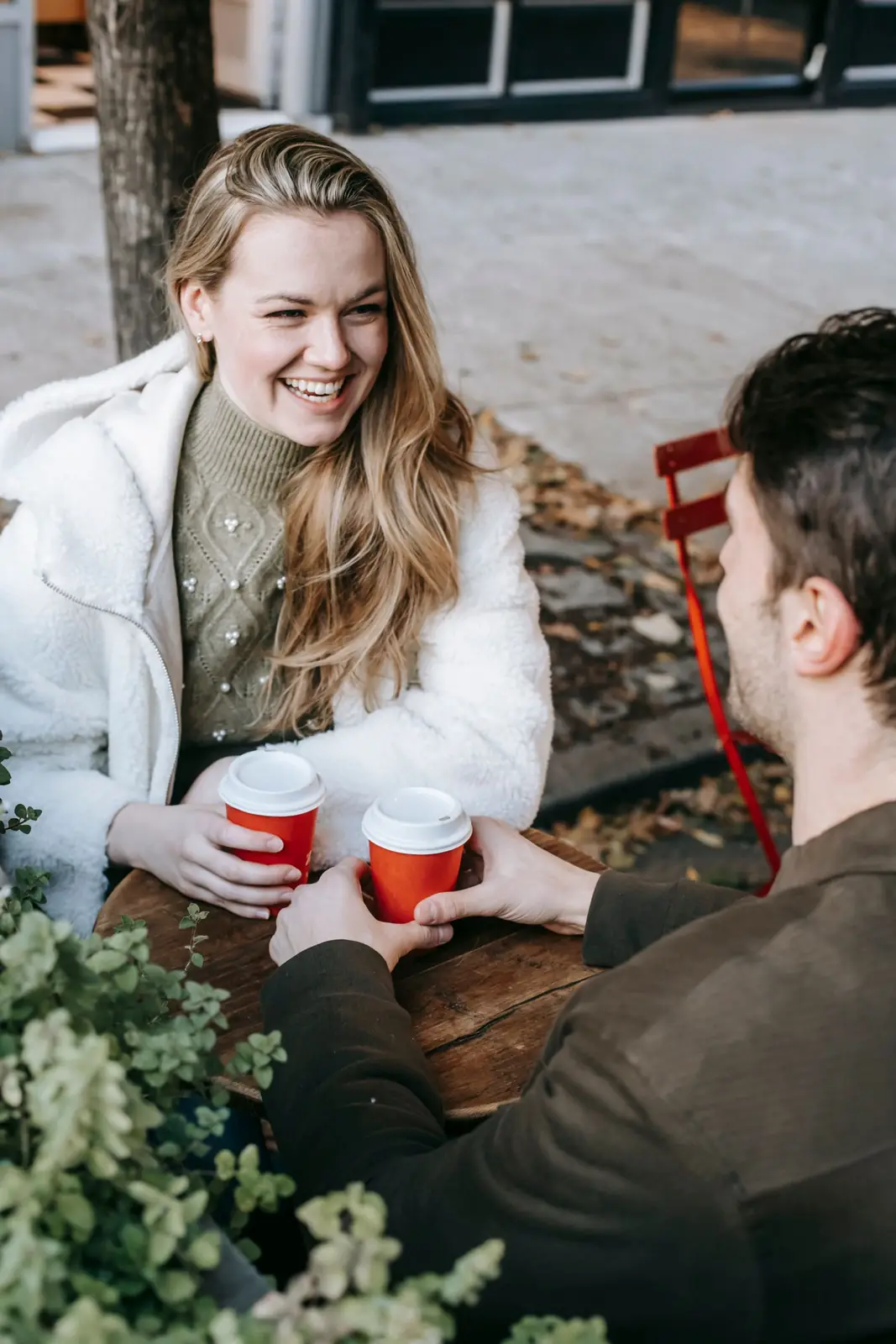 A woman laughing on a coffee date